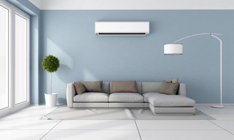 Ductless mini-split heat pump unit mounted on a living room wall