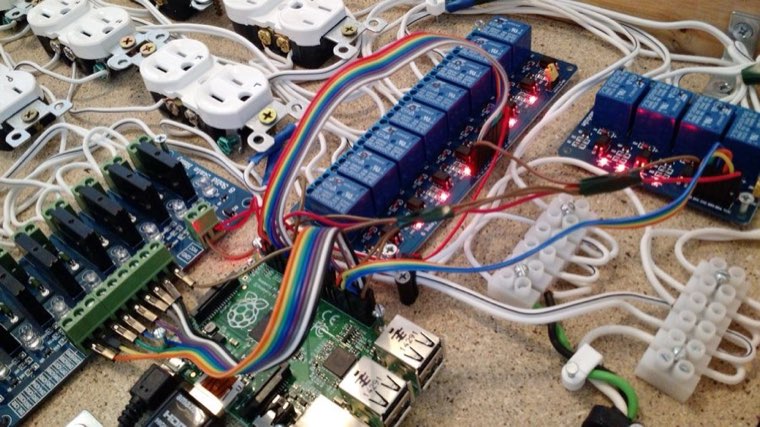 Industrial control build with relay boards, ribbon cabling and outlets on a workbench